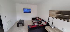 a living room with a couch and a table at Como en casa CRD 2 in Comodoro Rivadavia