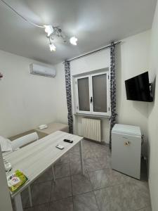 a small living room with a table and a television at La Marinella in Lamezia Terme