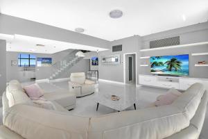 a living room with a couch and a tv at PH 2402 - SeaScape - Tweed Heads in Tweed Heads