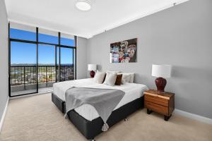 a bedroom with a large bed and a large window at PH 2402 - SeaScape - Tweed Heads in Tweed Heads +17 photos