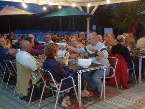 a group of people sitting at a table eating at Chalet 3 chambres avec terrasse pour 5 personnes - API-1-52-617 in Rives
