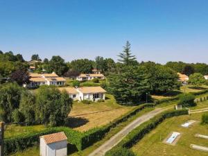 arial view of a house with a road in a field at Maison 55m² avec Terrasse, 2 Chambres, Capacité 5 personnes - API-1-52-745 in Prailles