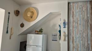 a white kitchen with a refrigerator and a staircase at TI BLUE plage à proximité in Les Trois-Îlets