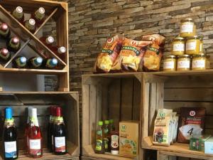 a shelf with bottles of wine and bags of bread at Mobil-home pour 6 avec terrasse à Avrillé - API-1-52-728 in Avrillé +5 photos