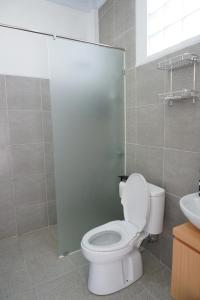 a bathroom with a white toilet and a sink at Habitat Boutique Dive Resort in Tulamben
