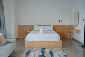 a bedroom with a bed with a teddy bear on it at Habitat Boutique Dive Resort in Tulamben +2 photos