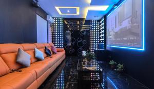 a living room with a couch and a large screen at Chengyu Jiaying Hostel in Lanzhou