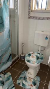 a bathroom with a toilet with a fish themed seat at Primrose Guest Houses in Nuku‘alofa +54 photos
