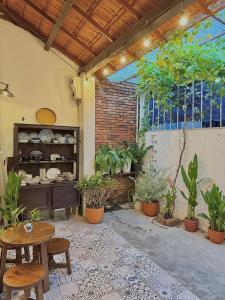 a patio with a table and chairs and plants at Peaceful Vietnamese - Style House, Yard & Bathtub in Da Nang +61 photos