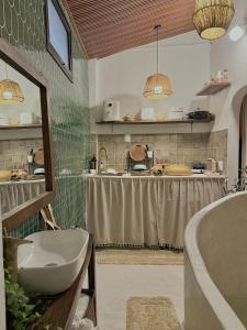 a bathroom with a tub and a sink and a counter at Peaceful Vietnamese - Style House, Yard & Bathtub in Da Nang