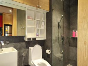 a bathroom with a white toilet and a shower at Nai Harn beach - Studio room on 2 floor at ReLife The Windy in Rawai Beach
