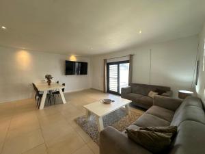 a living room with a couch and a table at Pelikaan apartment - Regal Rentals Curacao in Grote Berg