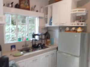 a kitchen with a white refrigerator and a window at NAIROBI NATIONAL PARK accomodation nearby in Nairobi