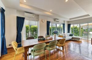 a living room with a wooden table and chairs at The SkyLanna Pool Villa Chiang Mai in Mae Rim