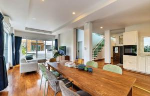 a living room with a wooden table and chairs at The SkyLanna Pool Villa Chiang Mai in Mae Rim +31 photos