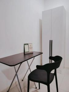 a desk with a laptop and a black chair at Netflix - City View Pano Studio with Skypool, Free parking and 5 mins to MRT in Kuala Lumpur +21 photos