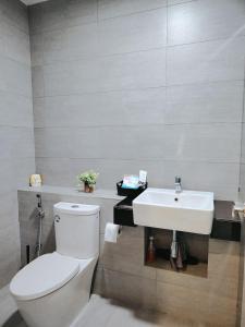 a bathroom with a white toilet and a sink at Netflix - City View Pano Studio with Skypool, Free parking and 5 mins to MRT in Kuala Lumpur