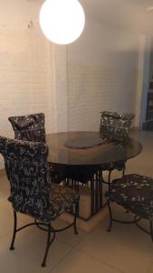 a dining room table with chairs and a light at Asia Casa in Asia