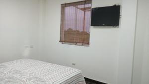 a bedroom with a bed and a television on the wall at Asia Casa in Asia