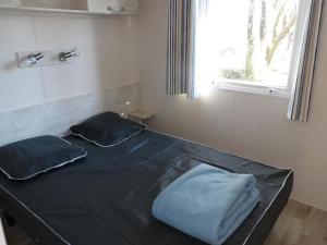 a bed in a room with two pillows on it at Cabane spacieuse avec terrasse au calme, idéale pour 8 personnes - API-1-52-790 in Saint-Sornin +28 photos