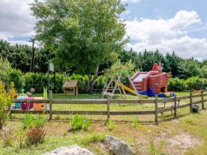 a park with a playground with a slide at Cabane spacieuse avec terrasse au calme, idéale pour 8 personnes - API-1-52-790 in Saint-Sornin