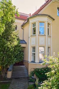 a large house with stairs in front of it at Painter's apartment by ZOO and Wrocław Congress Center in Wrocław