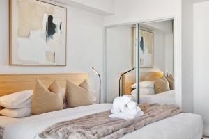 a bedroom with two beds with a blanket at Luxury 2 Bedroom 2 Bathroom Apartment Walk to Burswood Casino in Perth