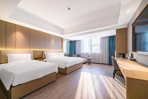 Postel nebo postele na pokoji v ubytování 杭州万信瑞铂酒店