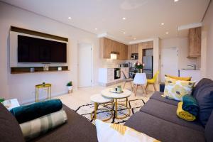 a living room with a couch and a table at Sandtongate Heights in Johannesburg