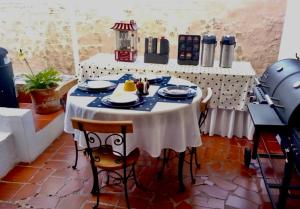 a table with blue and white dishes on it at La Posada de Jose Antonio in Villa de Leyva