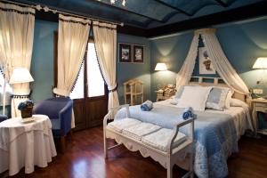 
a bedroom with a bed and a chair at Hotel El Ciervo in Vielha
