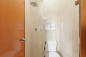 a bathroom with a toilet and a shower at RedDoorz Plus near Mall Sunter in Jakarta