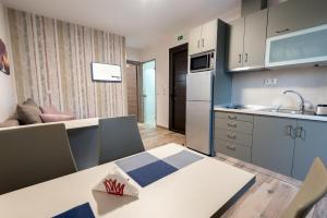 a kitchen with a table and a kitchen with a sink at Aventura Village in Potos