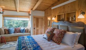 a bedroom with a large bed and a window at Jackson Hole Hideout in Wilson