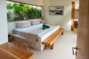 a bedroom with a large bed with a window at 2Bedrooms Bright&Modern Villa near Balangan Beach! in Jimbaran +32 photos