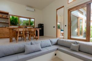 a living room with a couch and a table at 2Bedrooms Bright&Modern Villa near Balangan Beach! in Jimbaran