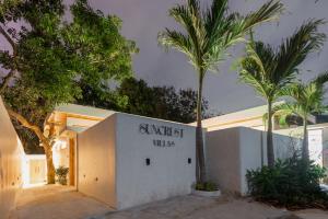 a building with a sign that reads sunset villas at 2Bedrooms Bright&Modern Villa near Balangan Beach! in Jimbaran