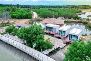 an aerial view of a resort on a river at หลานย่าโฮมสเตย์ บางตะบูน in Ban Khung Tamnak