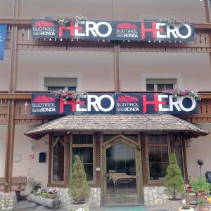 a store with a sign on the front of a building at Hotel Serena in Selva di Val Gardena