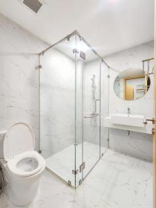 a bathroom with a shower and a toilet and a sink at Căn hộ TMS Pullman cao cấp Studio có ban công view biển - Golden Wave Homestay in Quy Nhon