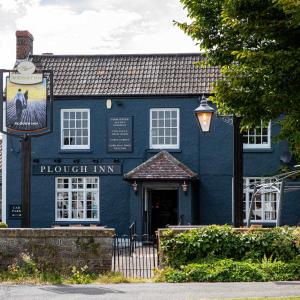 a blue building with a sign in front of it at Cozy Cottage, Wrington in Wrington