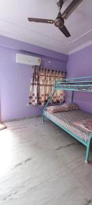a room with two bunk beds and a ceiling at Cosy Heights Vizag in Visakhapatnam
