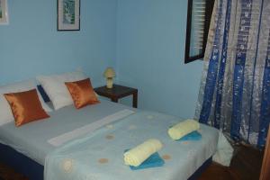 a bedroom with a bed with towels on it at Apartment Penovic in Blace