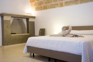 a bedroom with a bed with a stuffed animal on it at Da Pippi e Gesuina in Matino