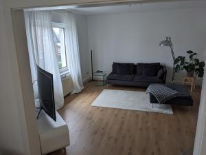 a living room with a couch and a tv at Fewo Steckinghof in Coesfeld
