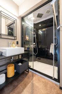 a bathroom with a sink and a shower at HOTEL TABARD TOKYO in Tokyo