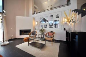 a living room with two chairs and a glass table at Villa de lujo de 4 dormitorios, piscina y barbacoa in Sant Feliu de Guixols
