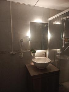 a bathroom with a sink and a shower with a mirror at Casa Manila Medellin in Medellín +73 photos