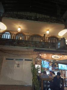a restaurant with people sitting at tables and a balcony at Casa Manila Medellin in Medellín