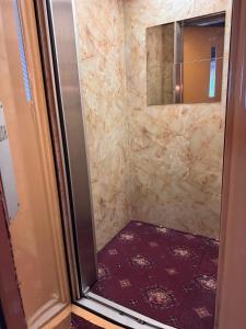 a bathroom with a shower and a mirror at RideSide Hotel in Blackpool +102 photos